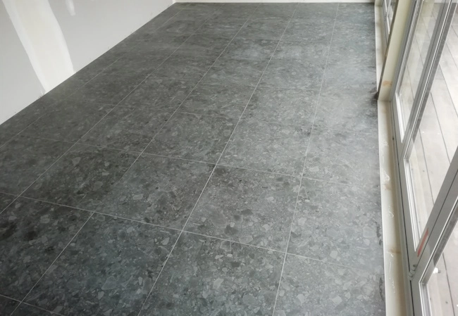 Floor tiled with dark grey stone-effect porcelain tiles in Long Bay home – Direct Tiling