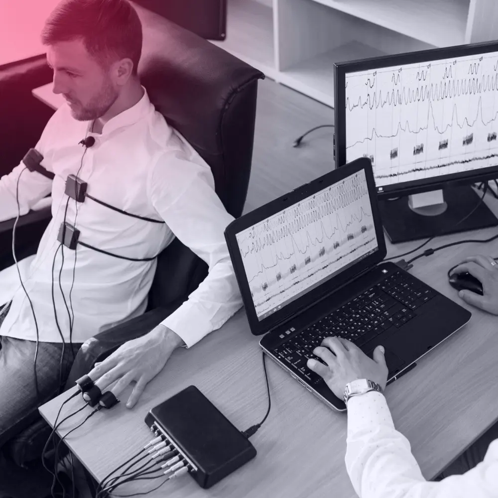 a man on a polygraph with sensors connected