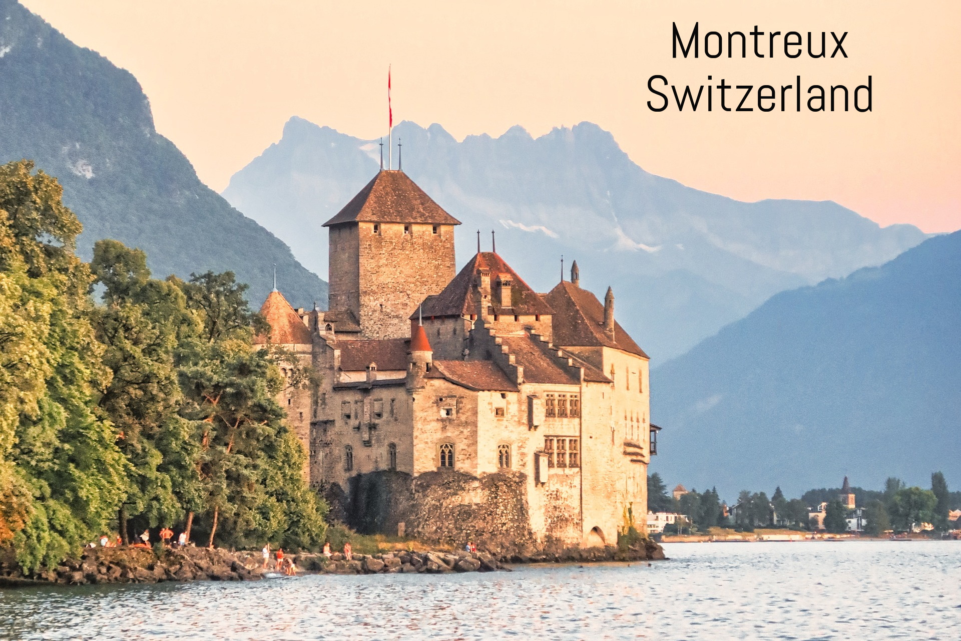 Scenic view of Chillon Castle by the lake in Montreux, Switzerland, with mountains in the background